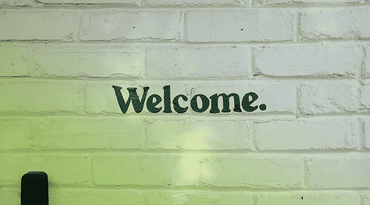 Welcome sign printed on brick wall